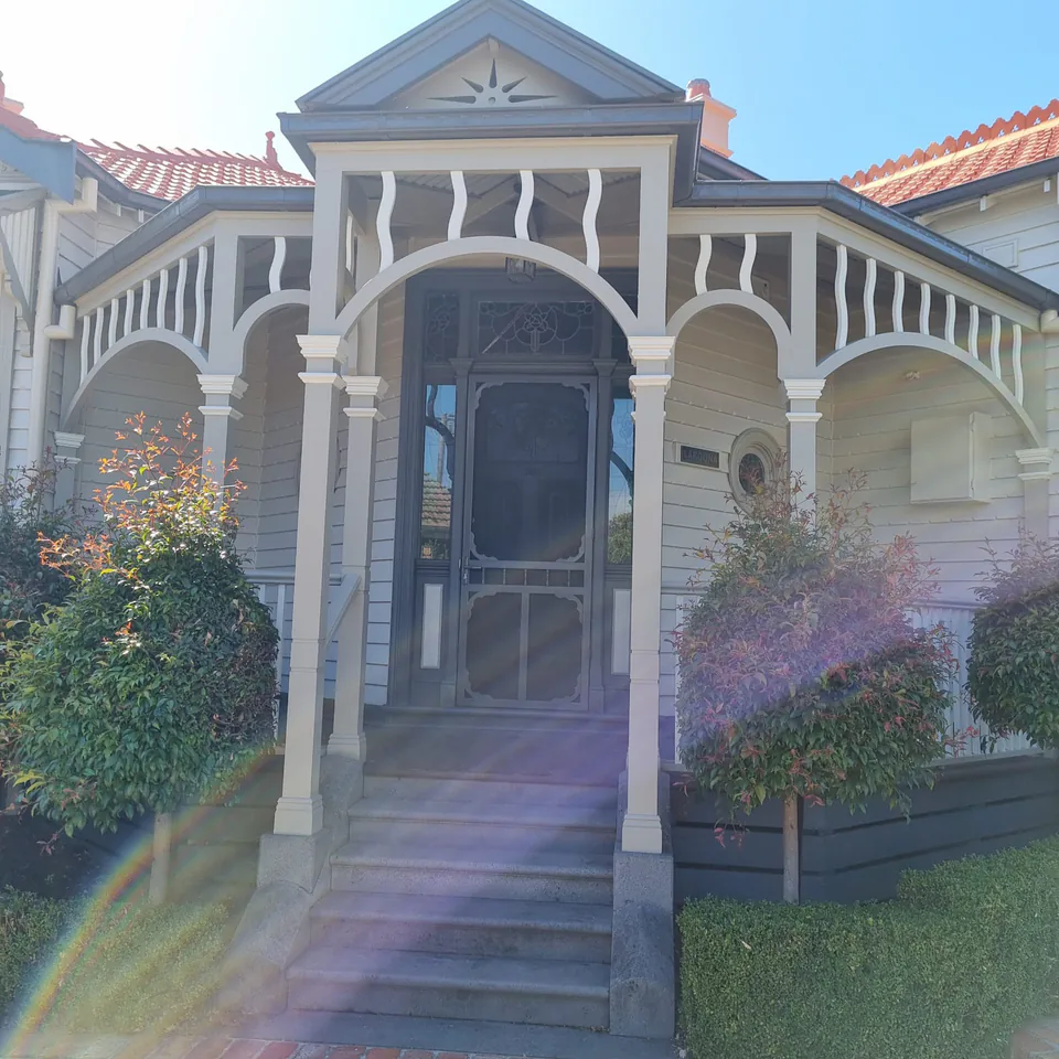 Renewed heritage weatherboard home exterior in grey and white