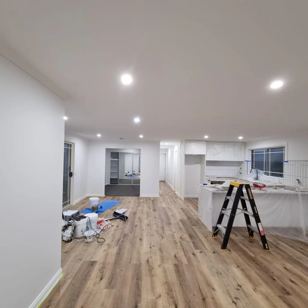 Bright open-plan interior with newly painted white walls and ceiling