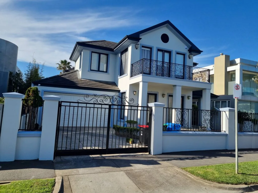 A two-storey Melbourne home with a crisp white exterior painted by Vic Diamond Painting
