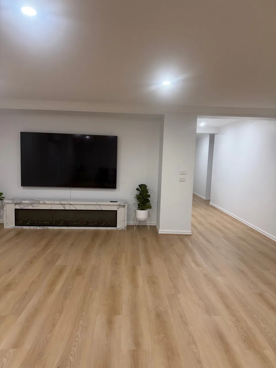 Freshly renewed Epping living room with white walls and timber flooring